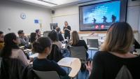 student is talking to the instructor at a workshop